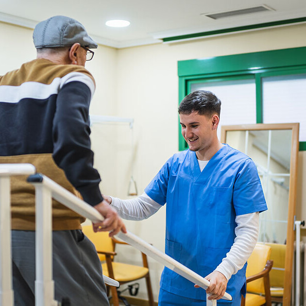 Physical therapist assisting a patient with gait training on rehab staircases in a physical therapy clinic.